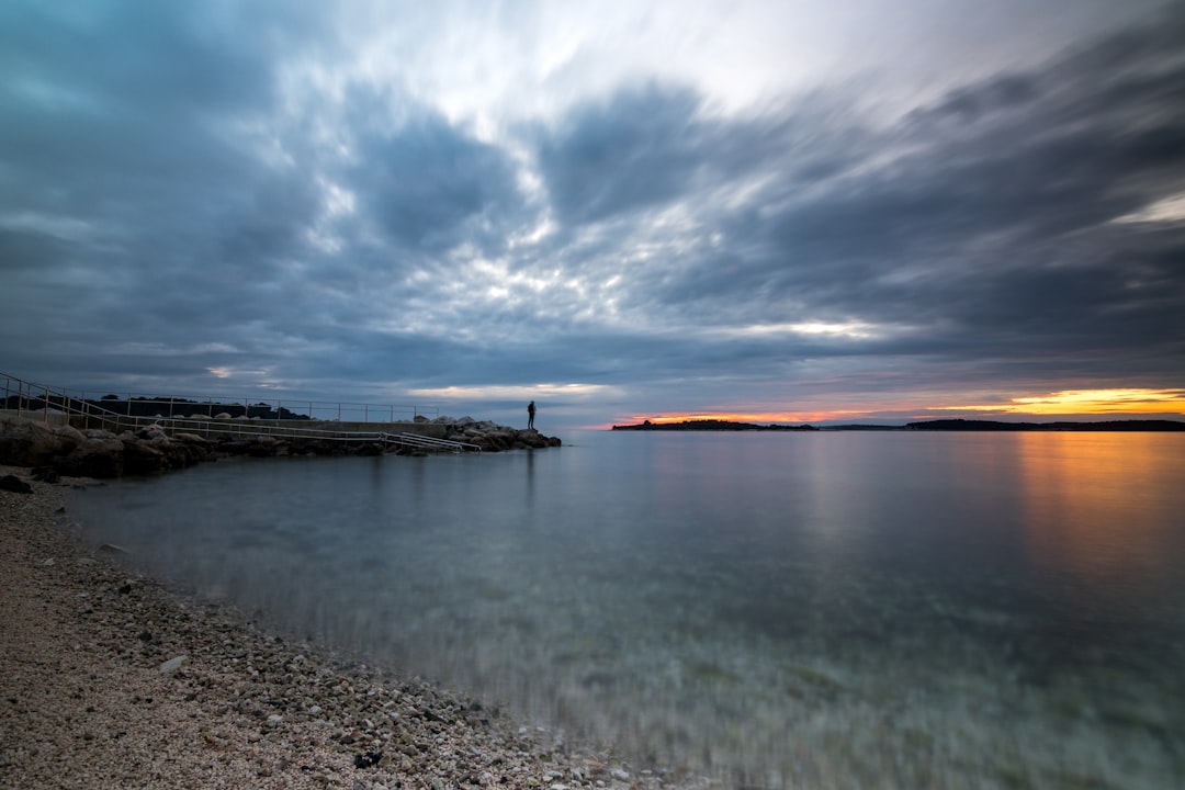 Bunice Beach Croatia pebbles calm water sunset